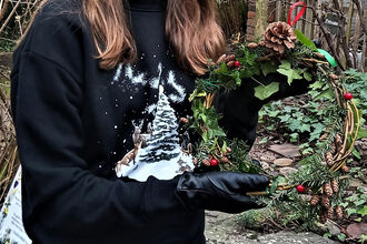 woman holding christmas wreath