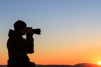 Photographer with sunset background
