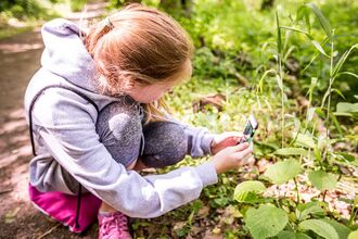 Student taking a photo on iNaturalist