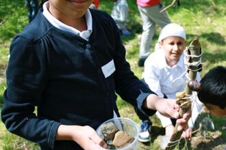 Image of a young person holding natural material