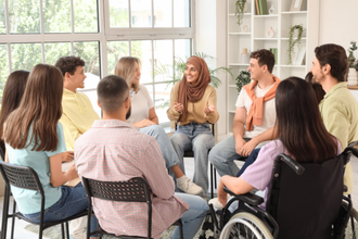 Group of individuals sat in a circle chatting