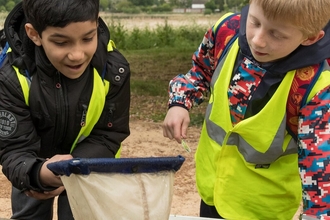 School children pond dipping