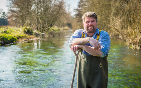 John standing in a river in his waders