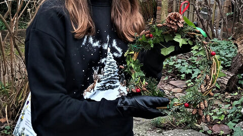 woman holding christmas wreath