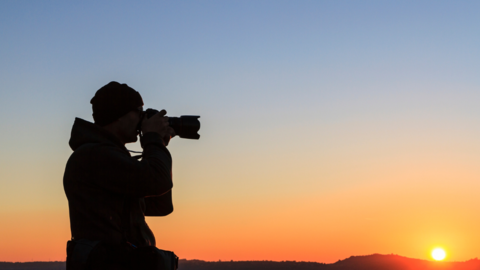 Photographer with sunset background
