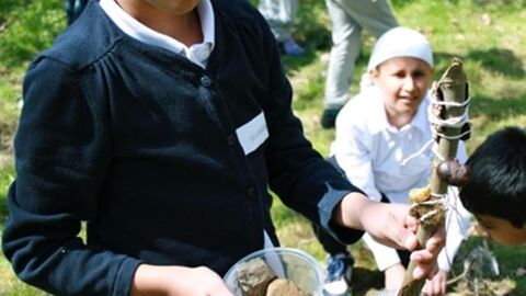 Image of a young person holding natural material