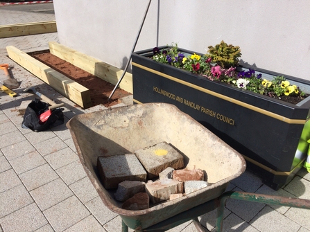 DePave: paving stones removed for raised beds at Hollinswood Neighbourhood Centre